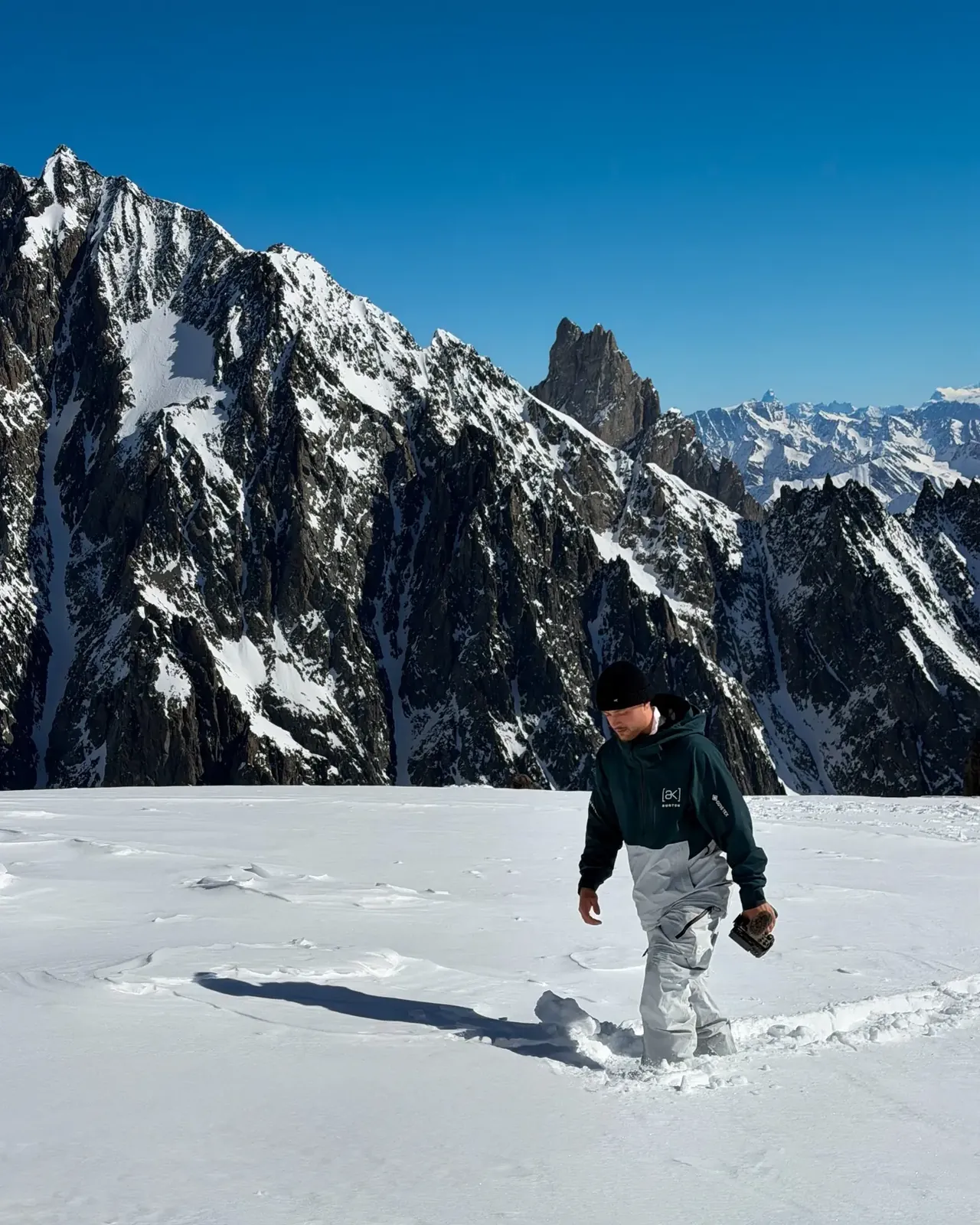 Filmmaker walking through deep snow in Courchevel