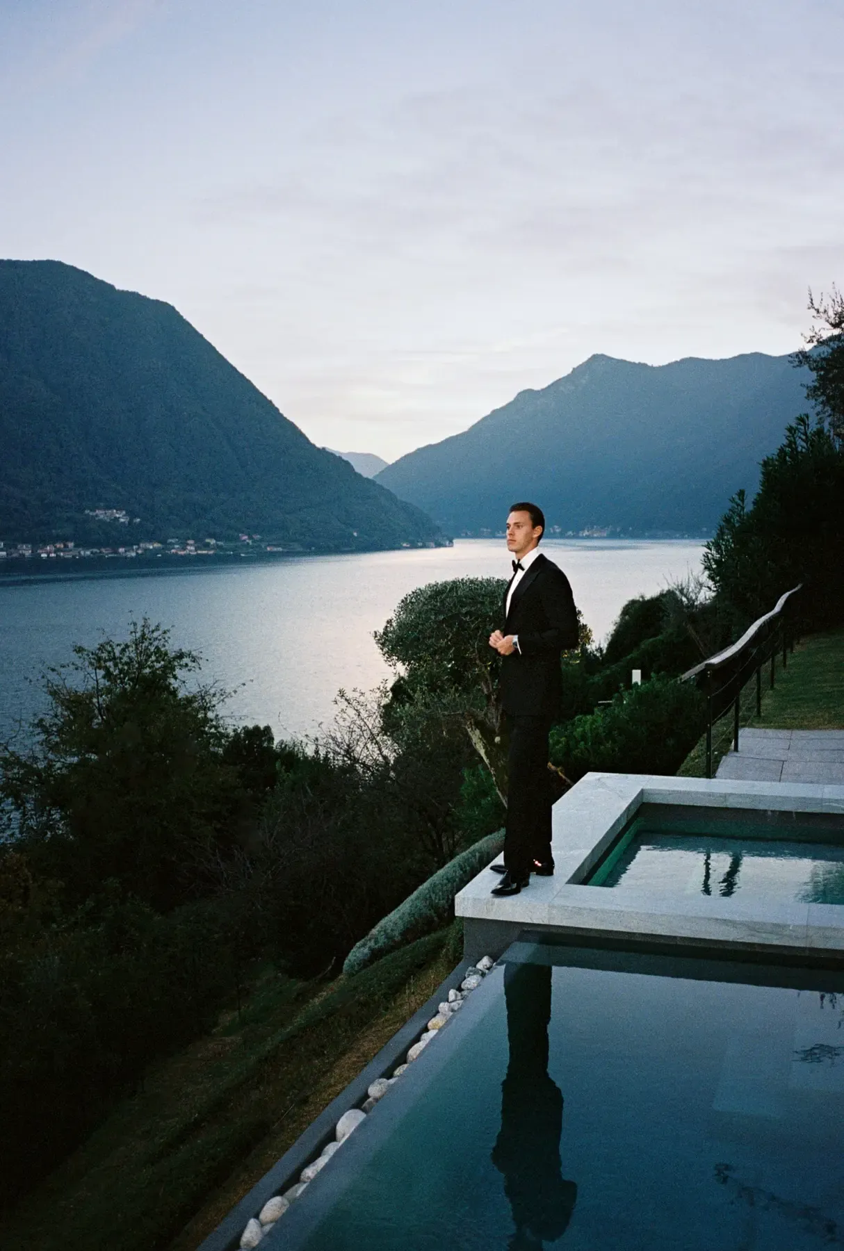 Man in formalwear overlooking Lake Como