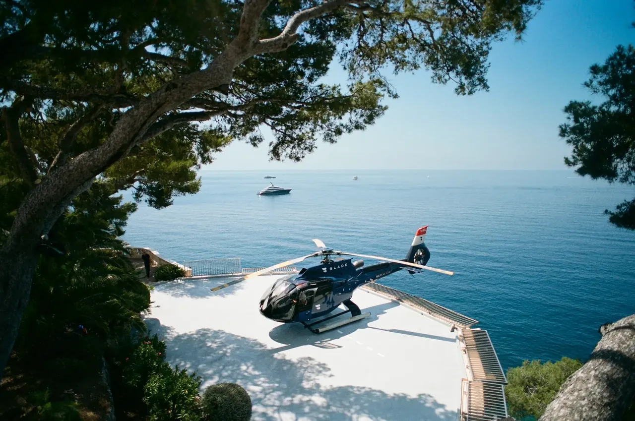 A helicopter on a private landing area above the Mediterranean