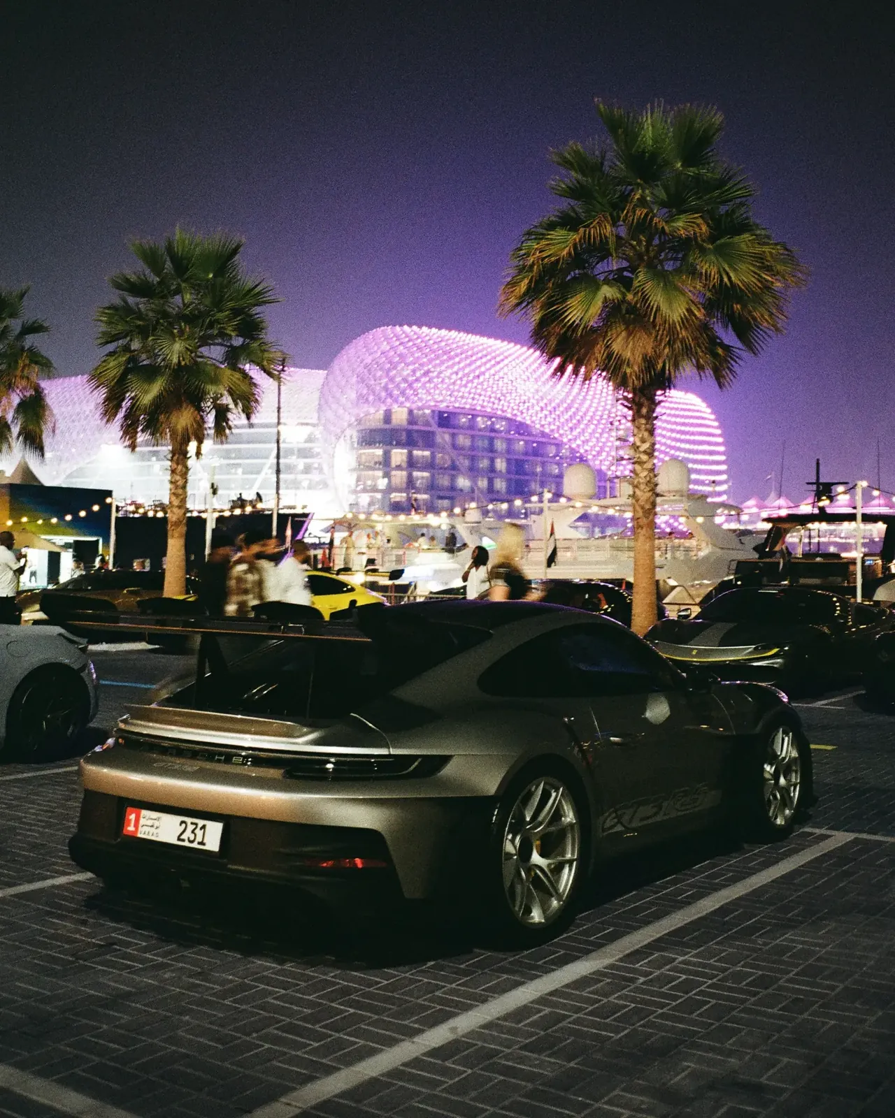 Sports car beneath illuminated architecture